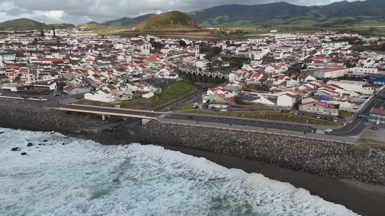 Droneoptagelse fra luften af den historiske havnefront og traditionelle hvide huse i Vila Franca do Campo, Sao Miguel Island, Azorerne. Portugisisk by beliggende langs Atlanterhavskysten.