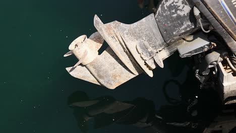 close-up of an outboard motor in water