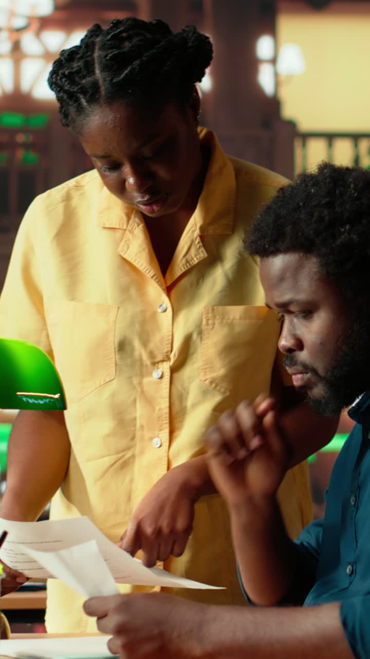 African American Business Colleagues Discussing Documents in Office