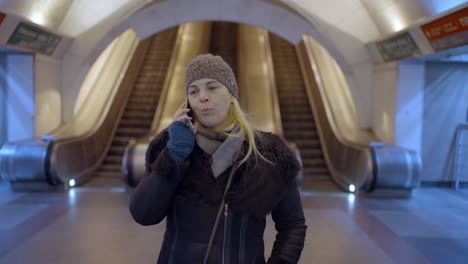 woman talking on her phone in a subway station