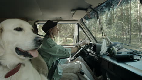 golden retriever dog traveling with woman in car