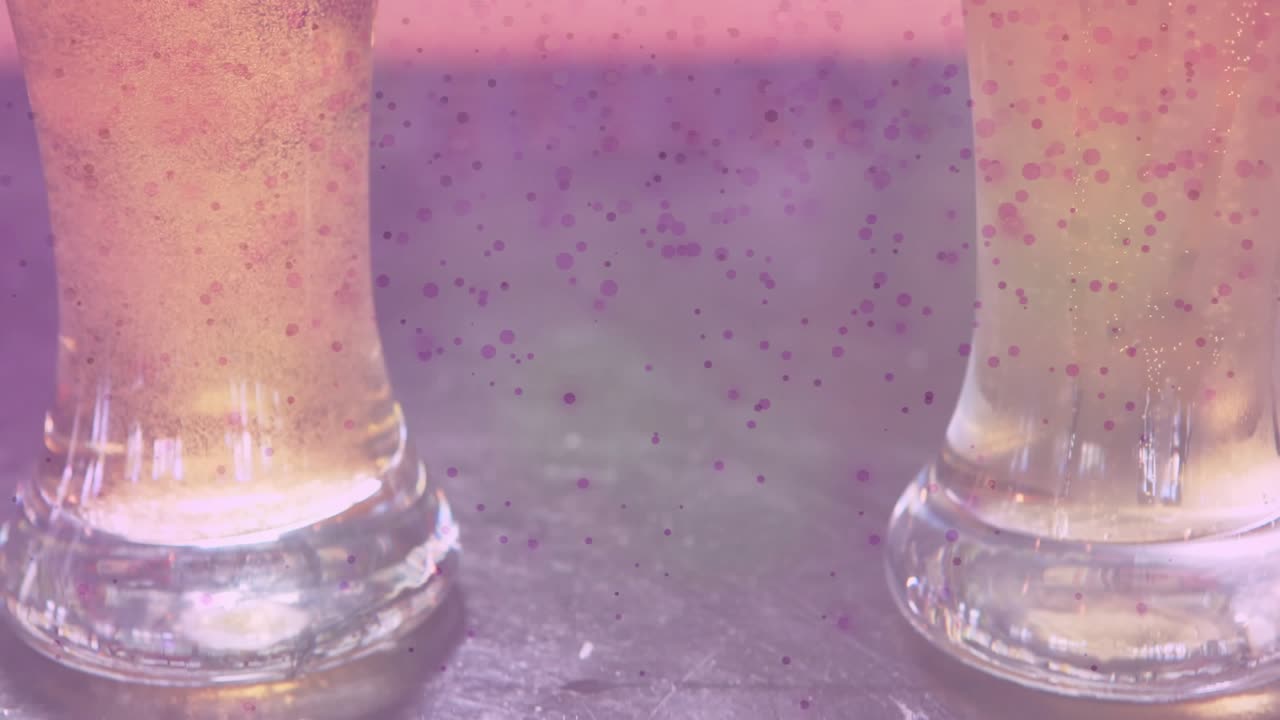 Speckled overlay appearing, camera revealing two pint glasses filling, foaming, showing carbonation