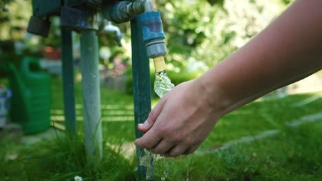 gardener washing hands in the outdoors tap