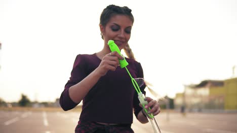 Young-Hipster-Girl-With-Long-Braids-Blowing-Bubbles