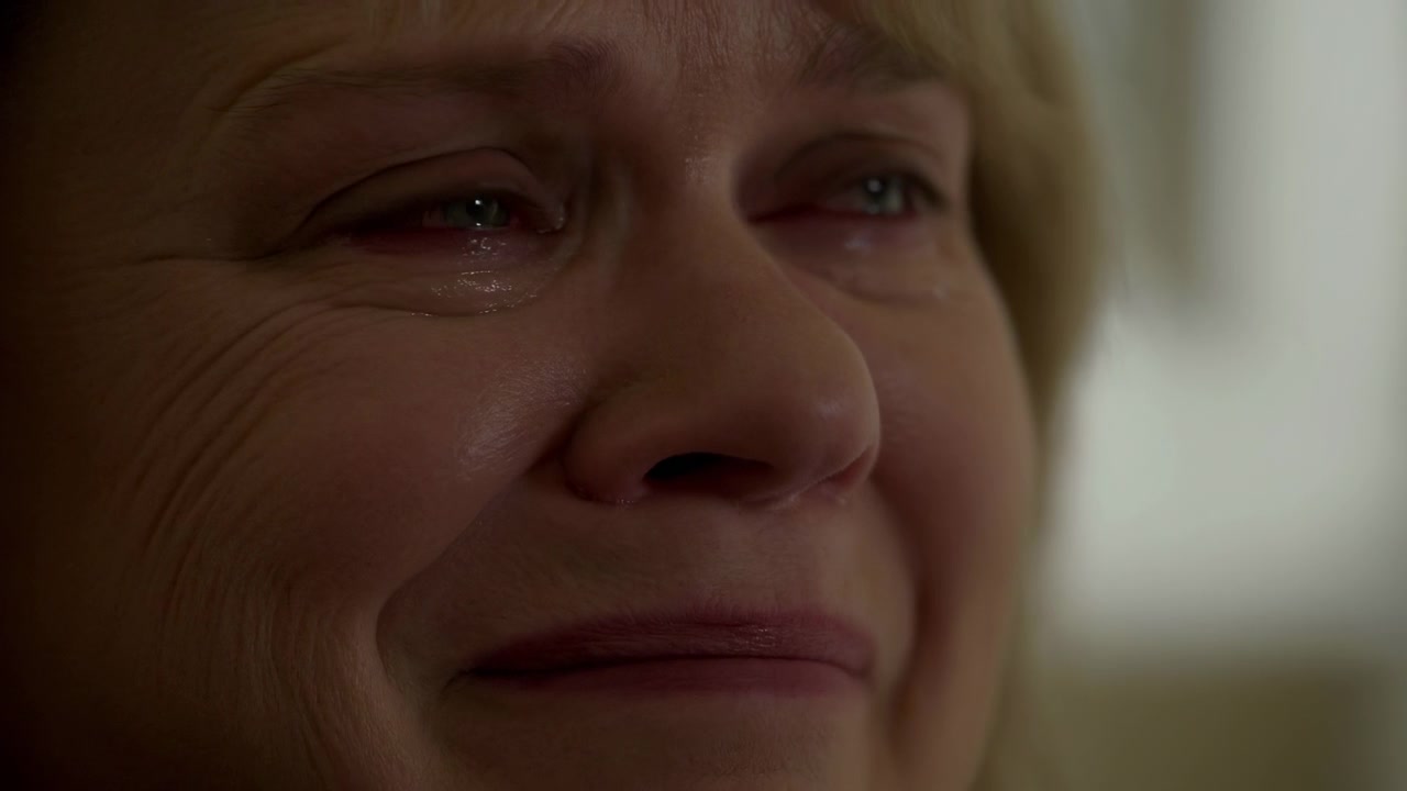 Closeup White Woman Crying Smiling, Tearstreaked Cheeks, Watery Eyes, Subtle Laugh Lines Intimate Indoor