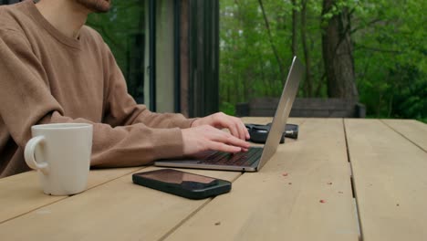 hombre trabajando en una laptop al aire libre