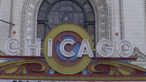 wide shot: static camera captures the theater sign atop a theater in chicago