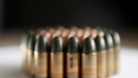 close up of many ammunition are arranged in a row and rotated with a rotating platform