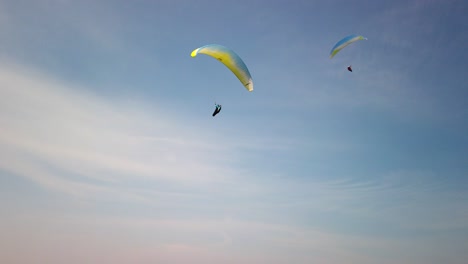 some paragliders fly along the steep coast of the baltic sea