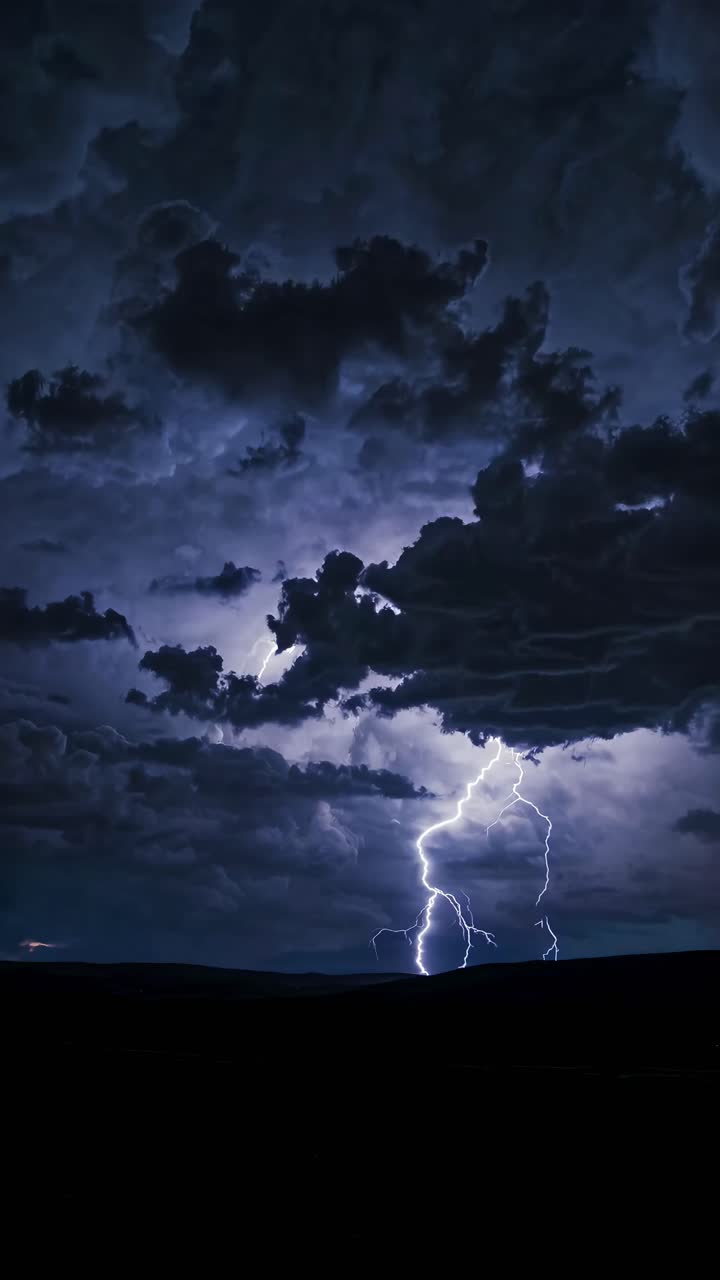 Dramatic video concept of a lightning bolt striking a dark landscape