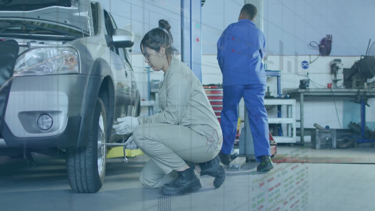 整備士が自動車整備工場でトルクレンチを選びラグナットを緩めており、アニメーション表示されたトルク値が見えている。