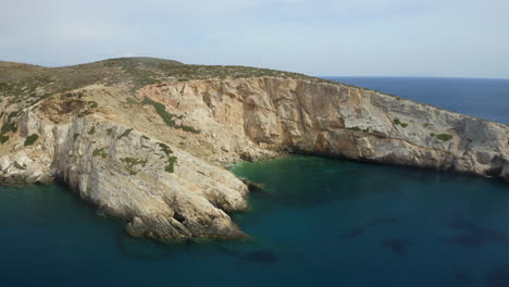 Drone-aerial-footage-revealing-Neverland-Bay,-in-Ios,-Greece-near-Maggnari-beach