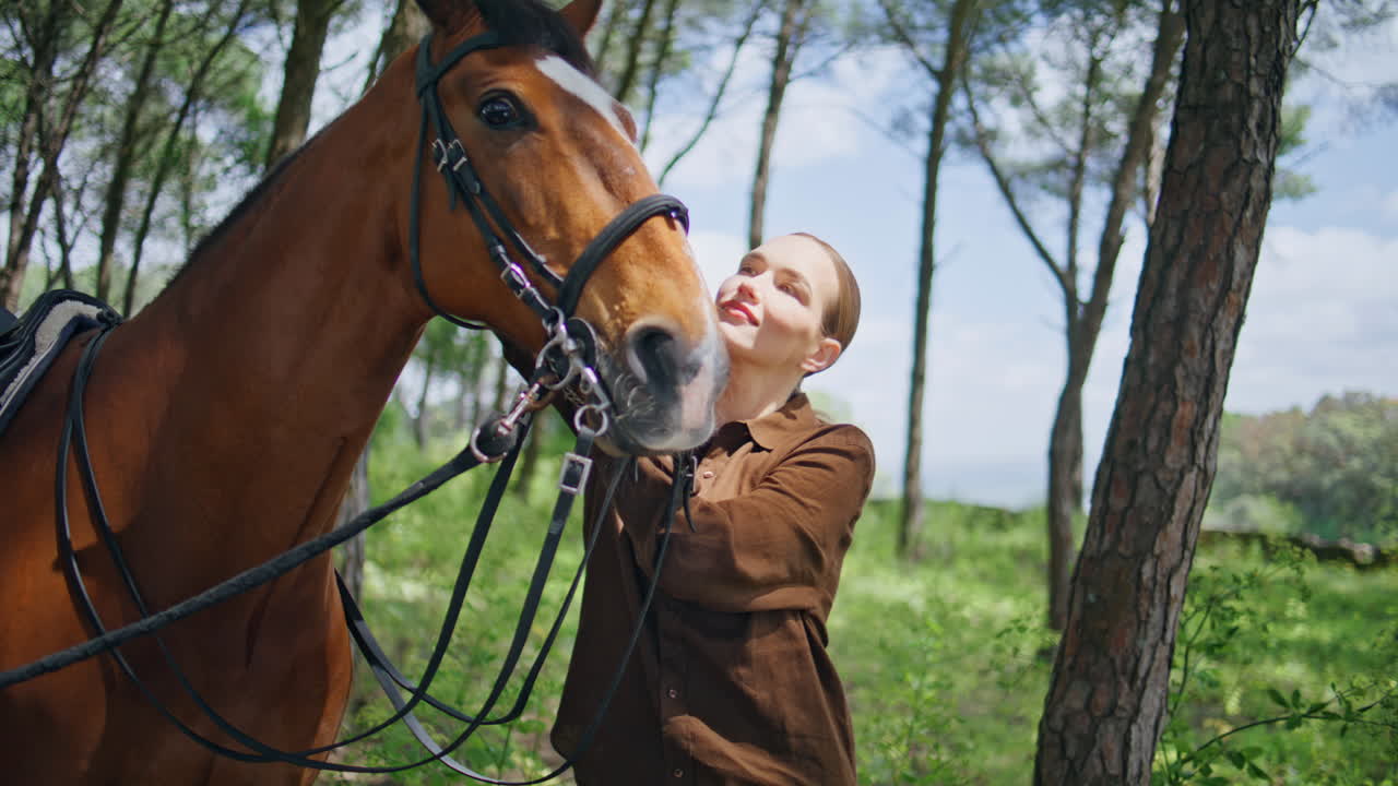 Joyful woman petting equine in green park closeup. Lady bonding with animal
