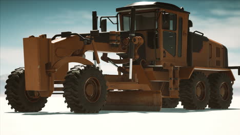 road grading machine on the salt desert road