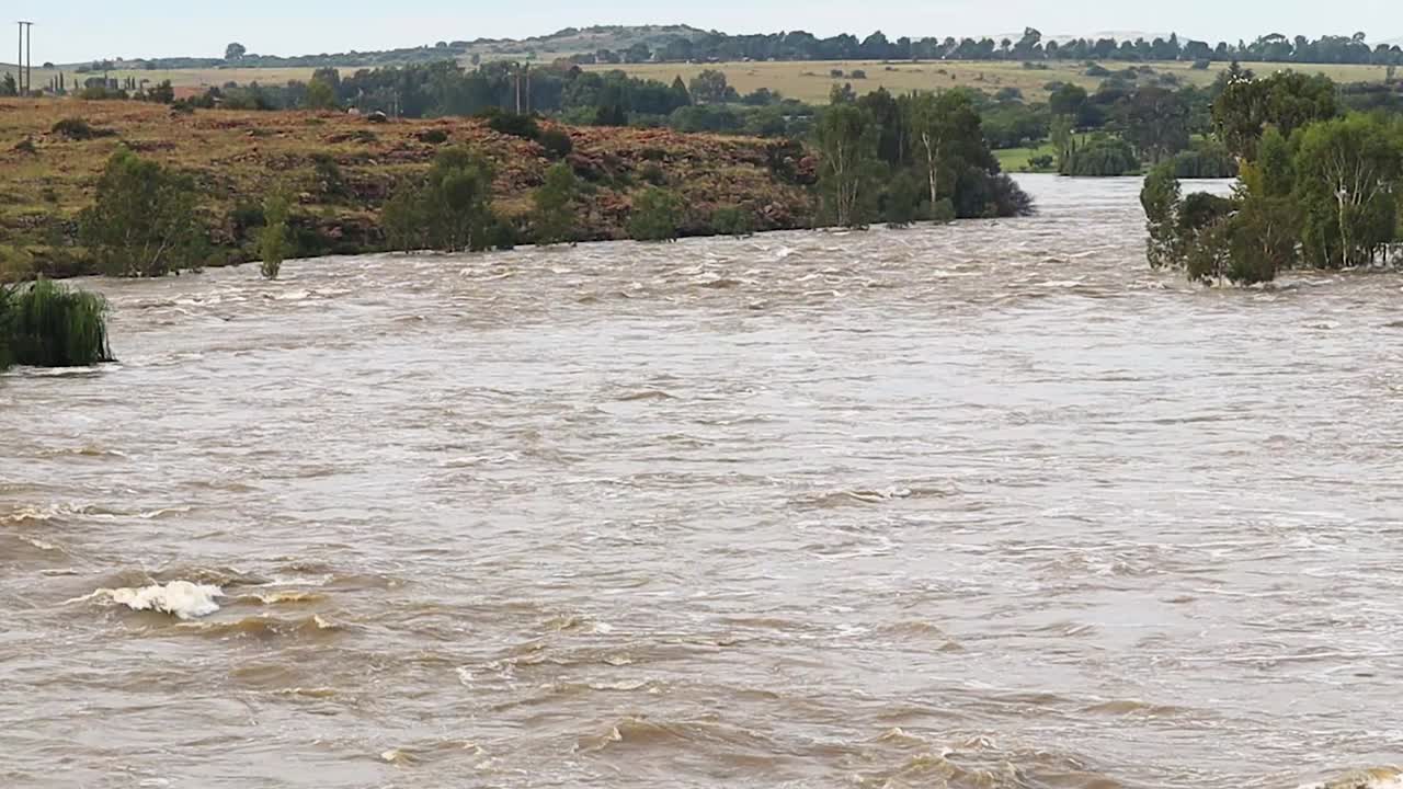 Fast flowing river flooding downstream, extreme weather, Vaal Dam South Africa