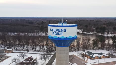 aerial, water tank tower in stevens point, wisconsin during winter season