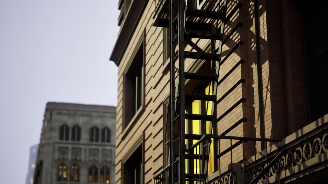 Building facade with fire escape and yellow window in urban area