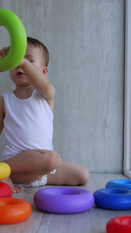 toddler playing with colorful rings