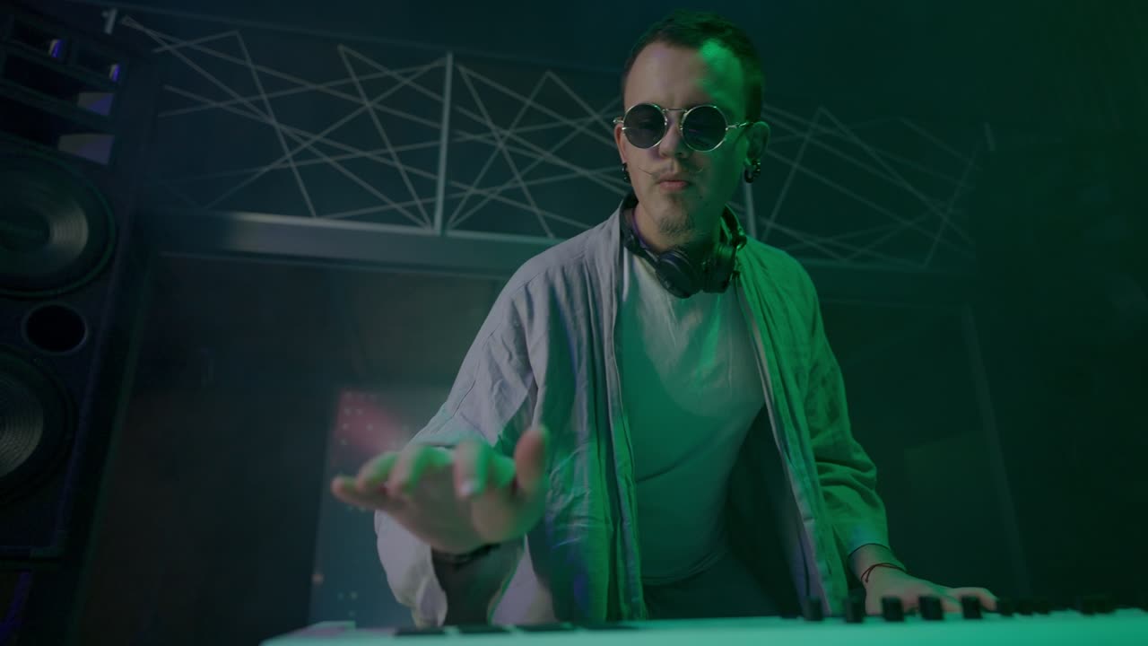 Bearded DJ makes professional live performance in club