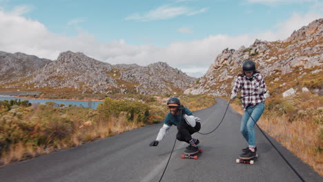 young multi ethnic friends longboarding together pulled behind vehicle having fun skating on countryside road enjoying exteme sport wearing protective helmet slow motion