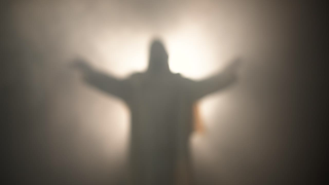 Resurrection of Jesus Christ in bright light inside the tomb, raising his hands in dramatic, cinematic slow motion. Perfect for Easter resurrection visual.