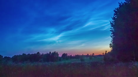 timelapse shot of gentle pastel sky at sunset with cirrus clouds passing by over rual landscape