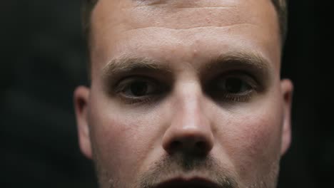 a man takes off his glasses and puts them back on, he is quite nervous, close up