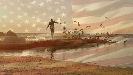 animation of flag of america over caucasian man in hat running on rocks with birds at sunset beach