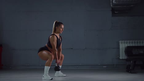 woman performing kettlebell exercise