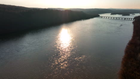 aerial of bridge across river in winter scene