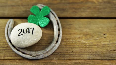 commposite image of horse shoe, rock written 2017 and shamrock for st patricks