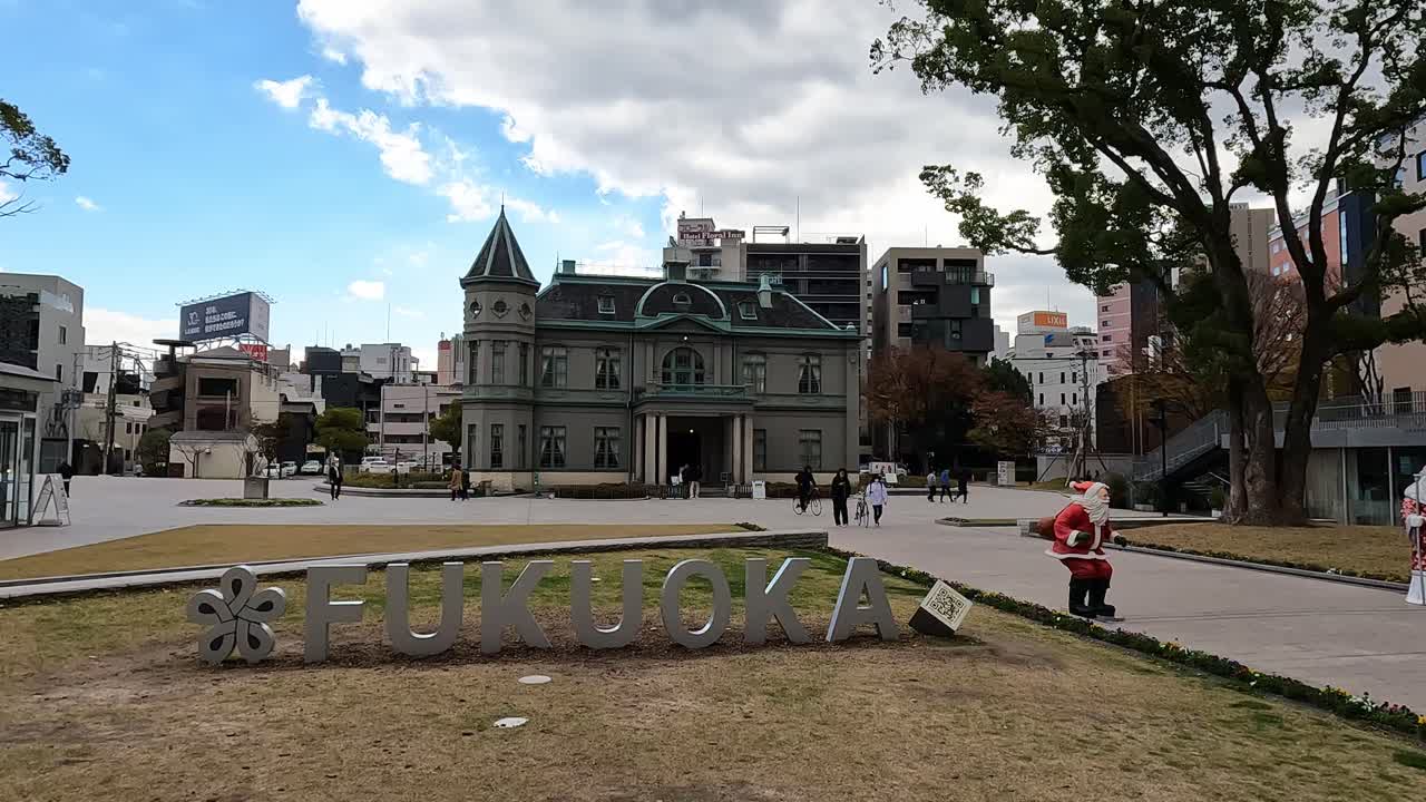 Fukuoka, Japan- An old building in Fukuoka, called &ldquo;Kihinkan Hall&rdquo; with christmas decoration and the city sign &amp;quot;fukuoka&amp;quot; in front of it