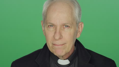 older priest shows concern, on a green screen studio background