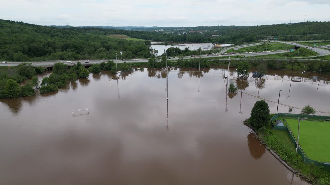 Flooded baseball, football and soccer fields damaged by extreme weather climate disaster