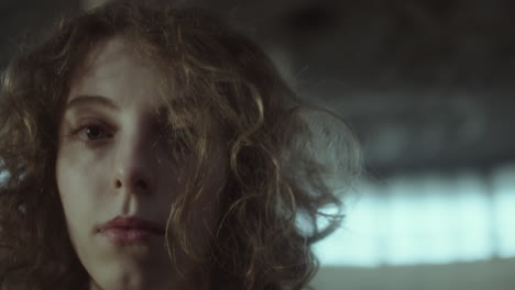 portraits of a young woman with curly hair