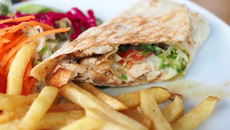 chicken wrap with fries and salad