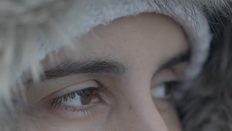 Slow-motion-close-up-shot-of-a-woman-wearing-furry-jackets-and-hats-and-looking-around