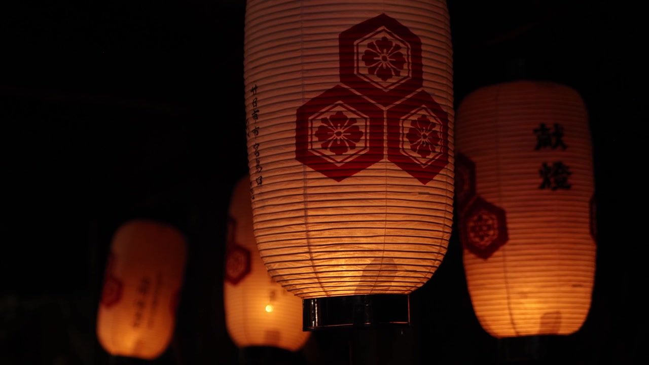 Illuminated traditional paper lanterns glowing during evening celebrations of the Kangen Sai Festival on Miyajima Island, Hiroshima, Japan