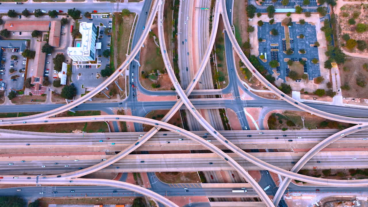 Multi-lane highways and trestles on the complicated road system. Traffic in the metropolis. Top perspective