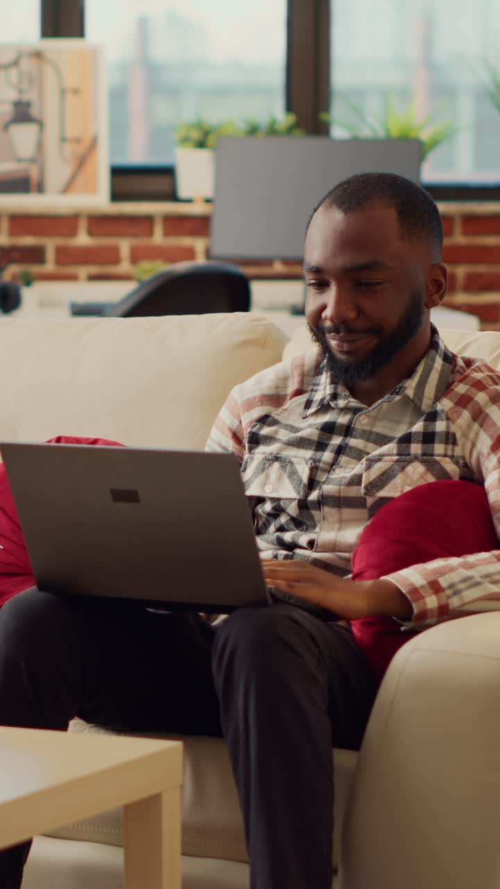 Vertical video: Boyfriend and girlfriend watching video on laptop together