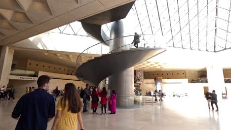 people walking inside louvre museum, paris