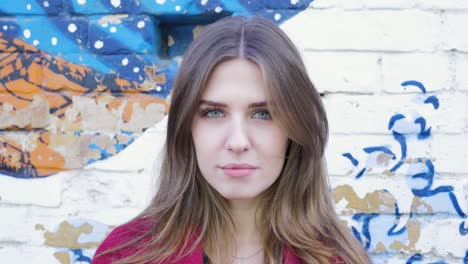 portrait of a woman in front of graffiti wall