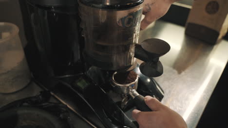 Grinding-coffee-beans-using-a-high-quality-coffee-grinder,-captured-with-a-close-up