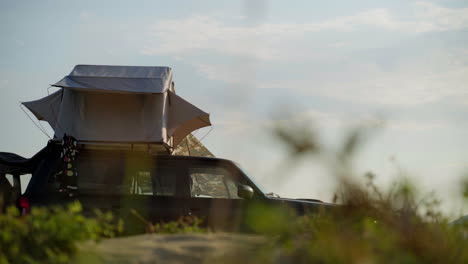 a camping car parked on a beach.