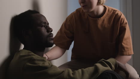 Sad man sitting on the floor