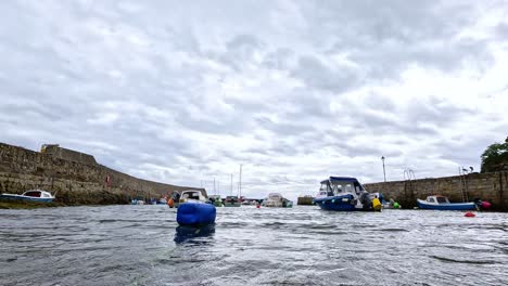 boats navigating and docking at dysart harbor