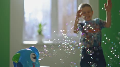 boy catches soap bubbles. portrait of kid going to catch the bubble