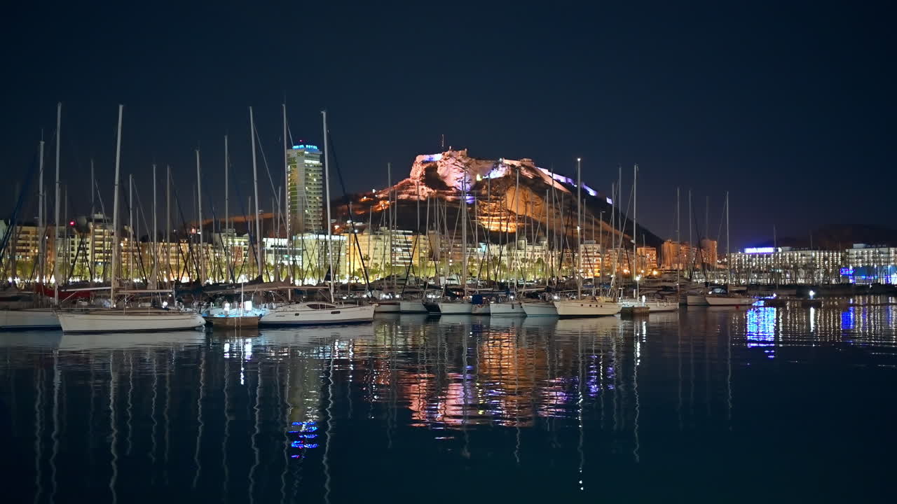 Night view of boats and yachts in Port of Alicante. Mountain Benacantil and the city in the background