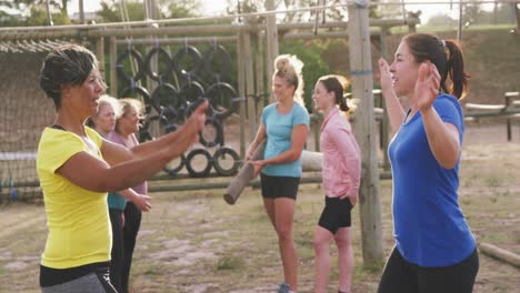 female friends enjoying exercising at boot camp together