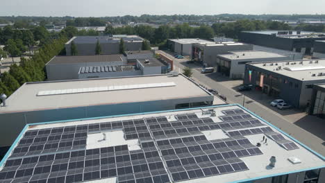 low aerial over photovoltaic solar panel on office rooftop on industrial terrain